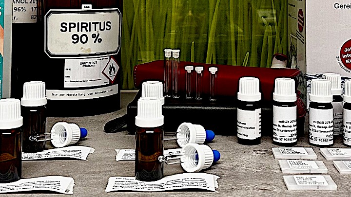 Various forms of packaging for homeopathic medicines, arranged on a table